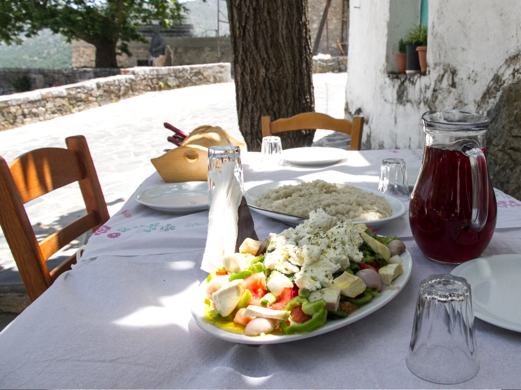 Table with traditional dishes and wine in a village